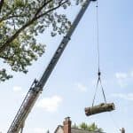 Crane lifting Red Oak section over Birmingham MI residential roof